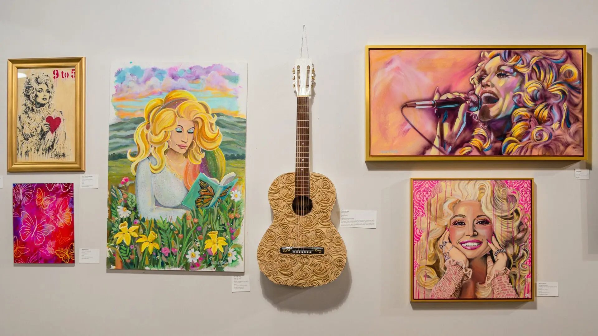 Dolly Parton artwork by local artists hanging on the Liberty Hall art wall at The Factory at Franklin